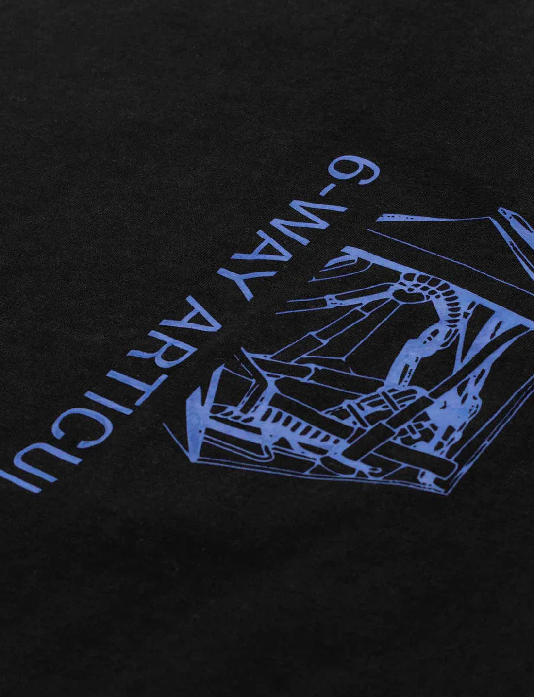 Close-up on the intricate blue drone graphic design on the back of Alan Walker's black Drone Repair Shop T-shirt, with reversed 'External Scanning Equipment' text.