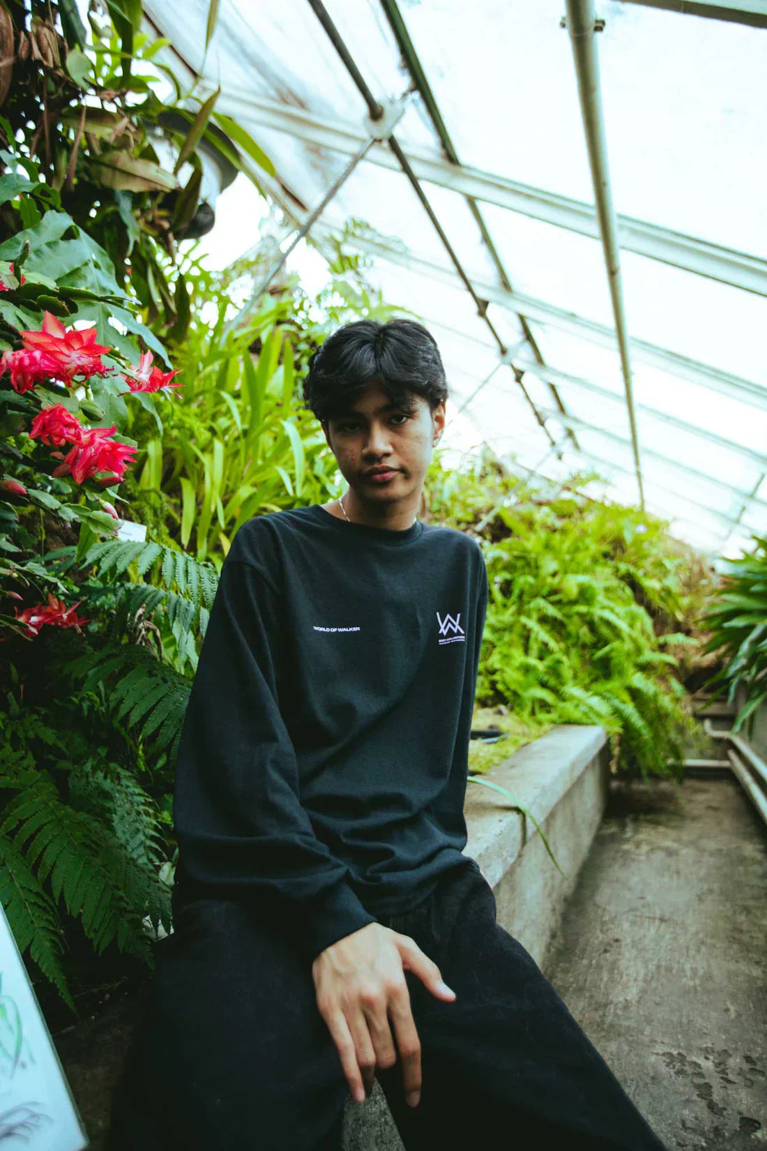 Casual yet fashionable, the Melting Rose Longsleeve worn by a male model in a serene greenhouse environment.