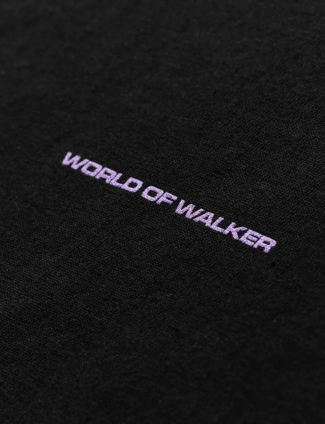 High-resolution detail of the 'World of Walker' print on the back of the T-shirt, symbolizing the Alan Walker brand.