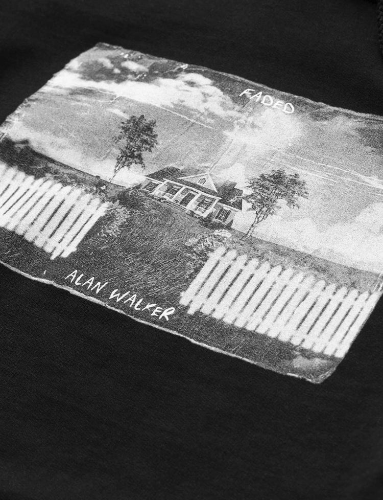 Close-up view of the graphic on Alan Walker's Faded 2.0 Hoodie featuring a monochromatic house and tree design with 'Faded' and 'Alan Walker' text.