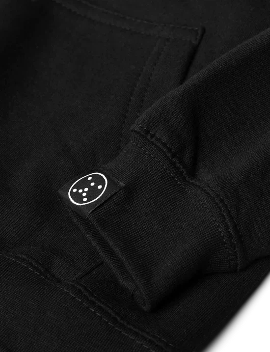 Close-up of the striking white Alan Walker logo on the back of the kids black hoodie, showcasing the brand.